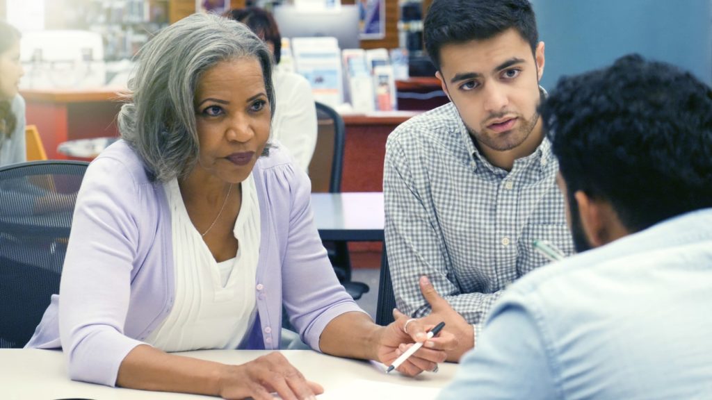 College student and parent meet with title 9 lawyer.